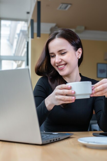 Beautiful businesswoman working on a laptop in a Female freelancer connecting