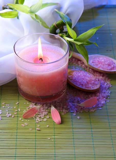 Beautiful candle on bamboo mat