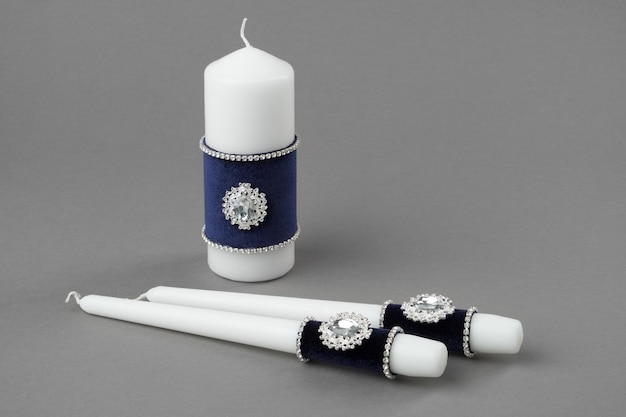 Beautiful candles decorated with velvet cloth and jewelry