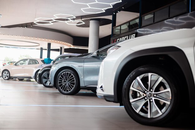 Beautiful Car dealership showroom interior with brand new vehicles for sale White floor for new car parking showroom park show waiting for sales