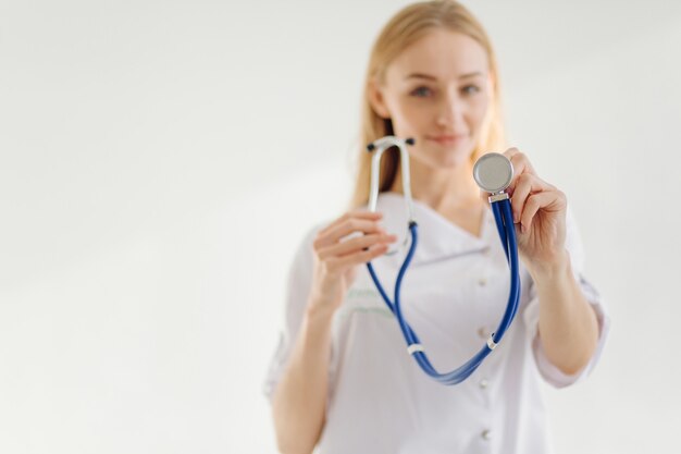 Beautiful caucasian blonde woman wearing doctor stethoscope