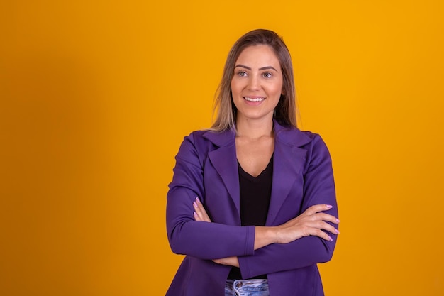 Beautiful caucasian business woman on yellow background smiling at camera Businesswoman in business clothes