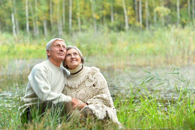 Beautiful caucasian elderly couple in the park in autumn