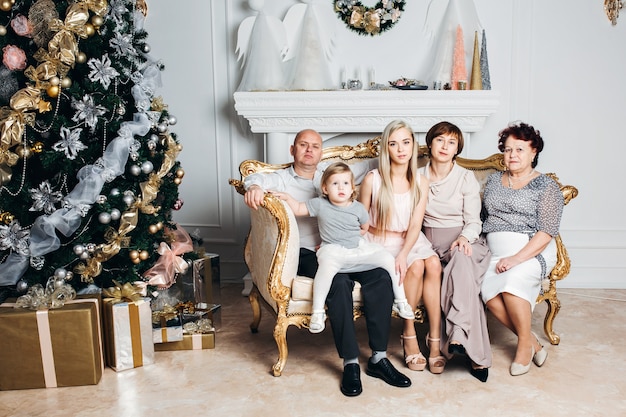 A beautiful Caucasian family near the Christmas tree