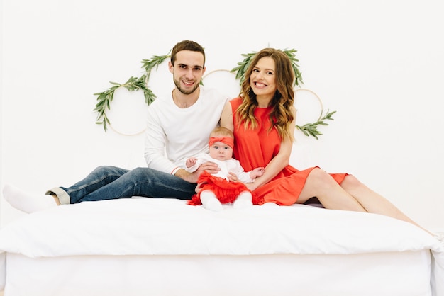 Beautiful caucasian family of three on a bed