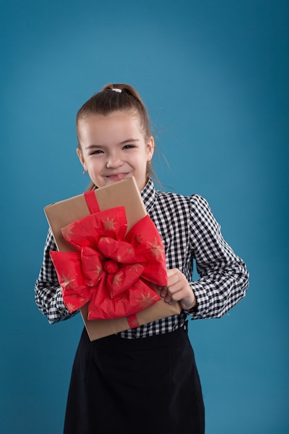 Beautiful caucasian girl holding a big gift in hands for Valentine's Day