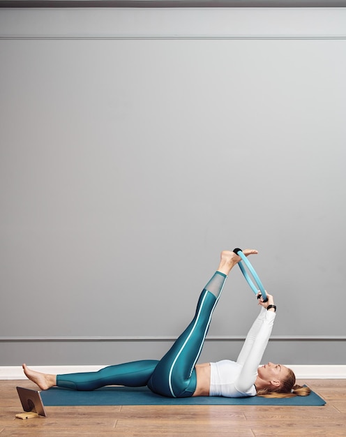 Beautiful caucasian girl working out at home. Brunette girl in squat position working out glutes.