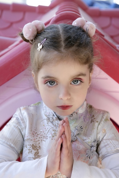 Beautiful caucasian little girl with asian dress