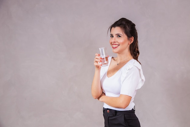 Beautiful caucasian woman drinking a glass of water.