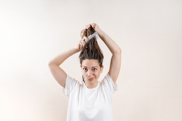 Beautiful caucasian woman girl with wet messy hard after bath. Thin hair problem. Isolated