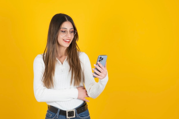 beautiful caucasian woman using smartphone Excited girl texting messaging on her mobile phone