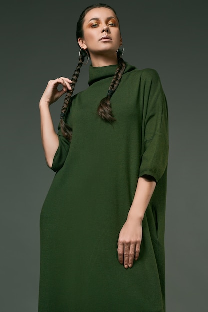 Beautiful charming hispanic girl in long green dress