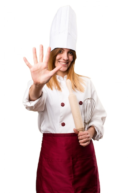 Beautiful chef woman counting five