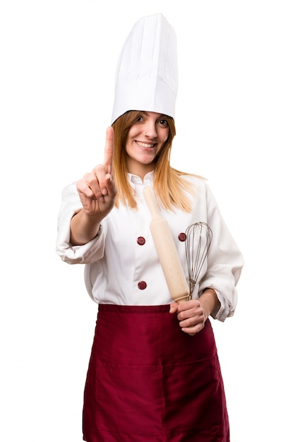 Beautiful chef woman counting one