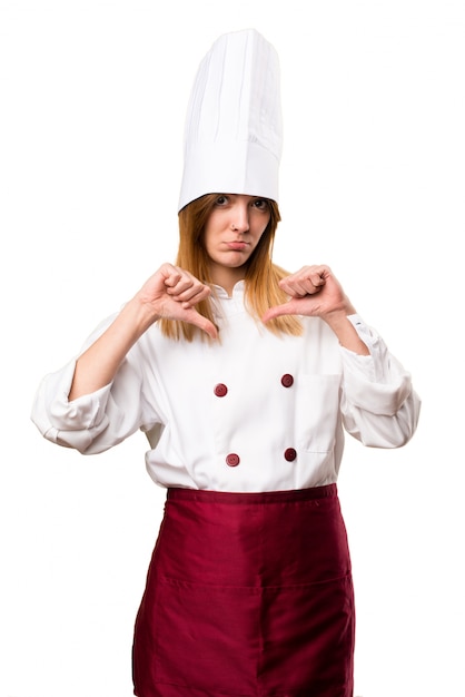 Beautiful chef woman making bad signal