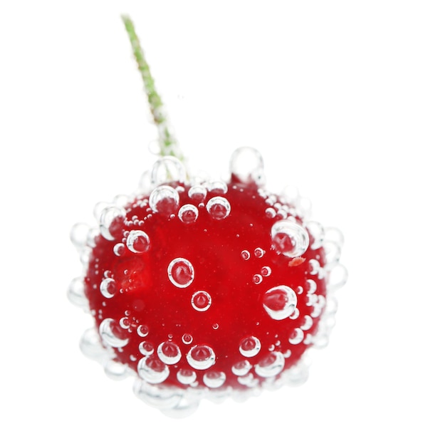 Beautiful cherry in water with bubbles isolated on white