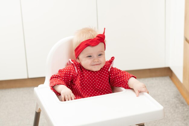 Beautiful Child Sitting in High Chair