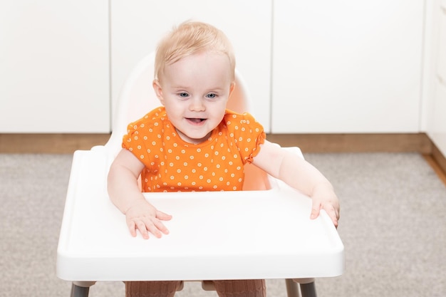 Beautiful Child Sitting in High Chair