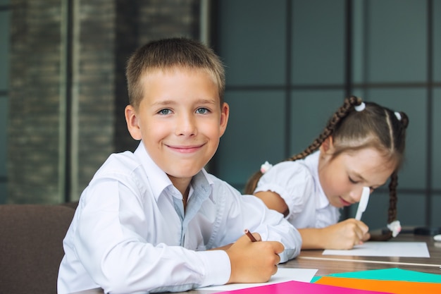 Beautiful children are students together in a classroom at the school receive education happy