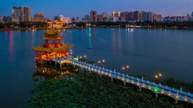 Beautiful Chinese Pagoda with Kaohsiung city in background at night, Wuliting, Kaohsiung, Taiwan.