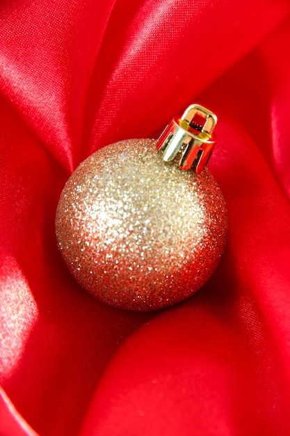 Beautiful christmas ball on red satin cloth