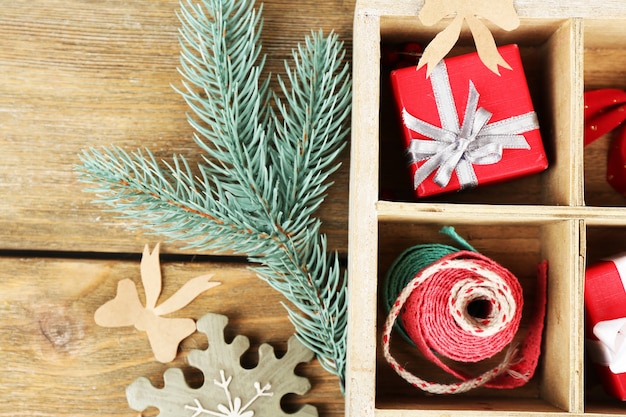 Beautiful Christmas composition with gifts in wooden crate