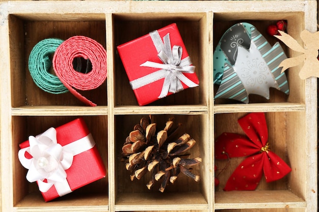 Beautiful Christmas composition with gifts in wooden crate