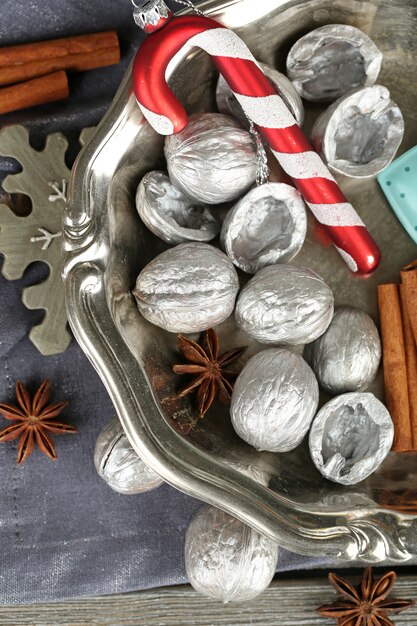 Beautiful Christmas composition with silver walnuts, on wooden table