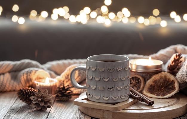 Beautiful christmas cup and candles on blurred background with bokeh