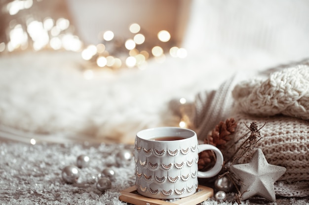 Beautiful Christmas cup with a hot drink on a light blurred background. concept of home comfort and warmth.