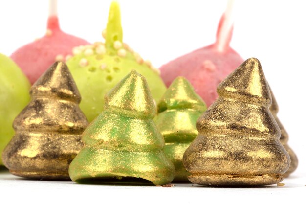 Beautiful Christmas dessert Cake pops and chocolate Christmas trees on a white background