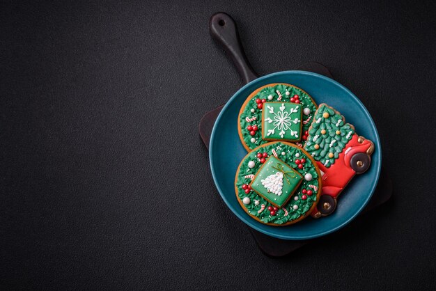 Beautiful Christmas gingerbread cookies on a round ceramic plate on a textured concrete background