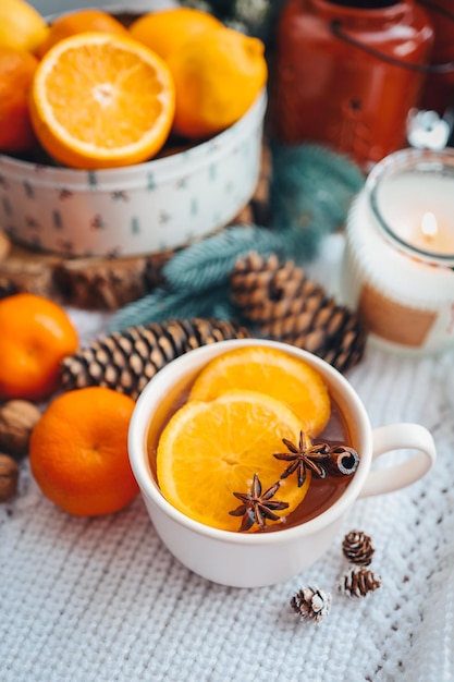 Beautiful Christmas still life A cup of hot tea with a knitted sixth plaid on the windowsill with New Year's decor