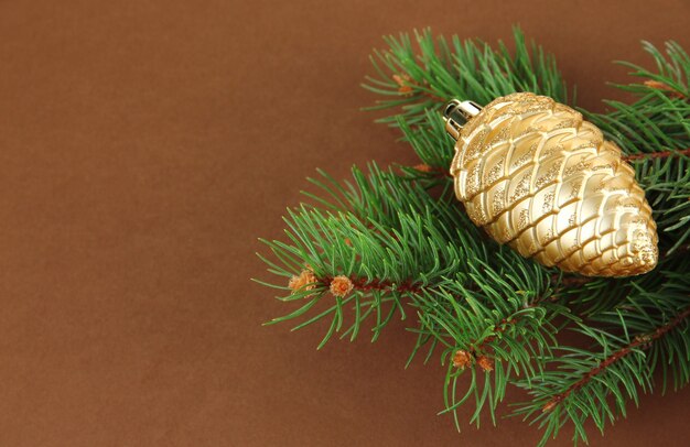 Фото Красивая новогодняя игрушка на елке на коричневом фоне