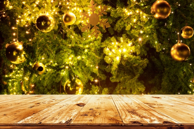 Beautiful Christmas tree backdrop and lights with top of empty wood table. ready for your product display or montage