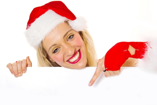 Beautiful christmas woman in santa hat holding empty board