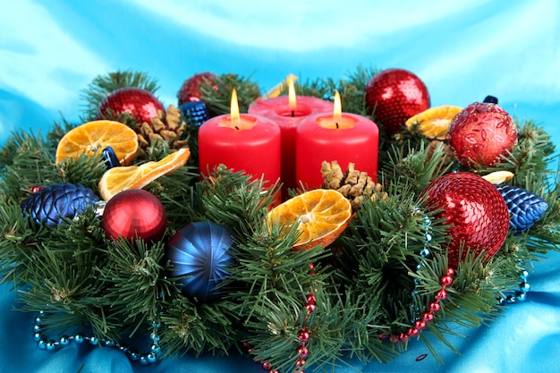 Beautiful Christmas wreath on blue fabric surface