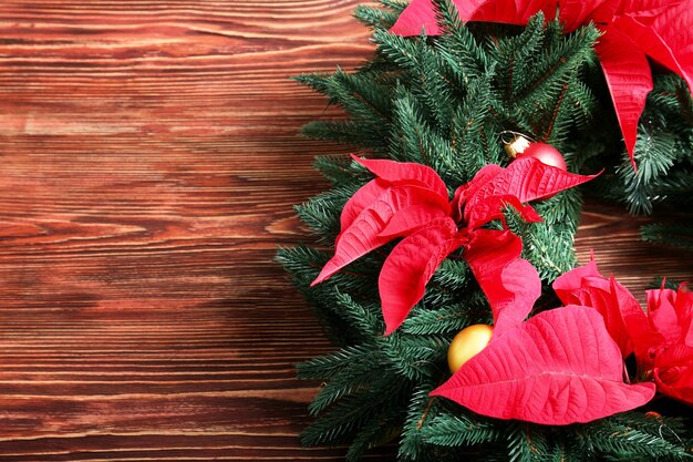 Beautiful Christmas wreath on wooden table, closeup