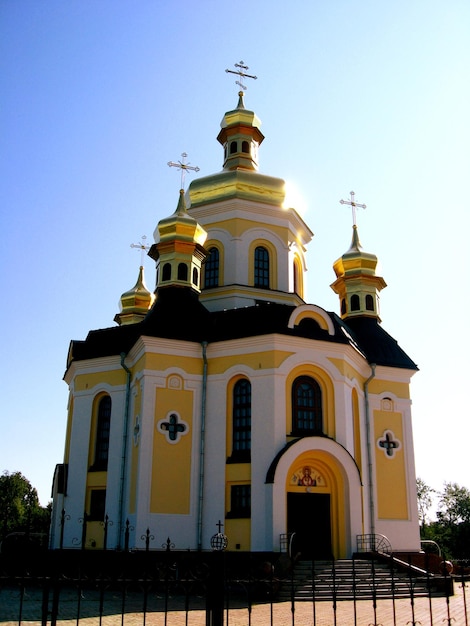 Beautiful church with golden domes on a background of the blue sky