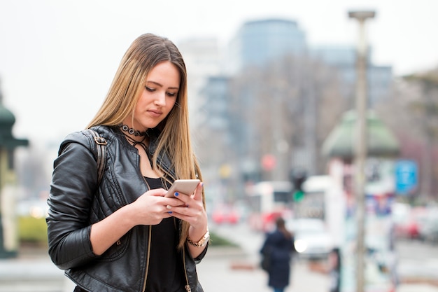 Beautiful city girl texting .