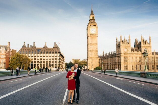 Beautiful city and people Young family couple stand on Westminster bridge in background with Big Ben enjoy free time together in London have good relationships City landscape background