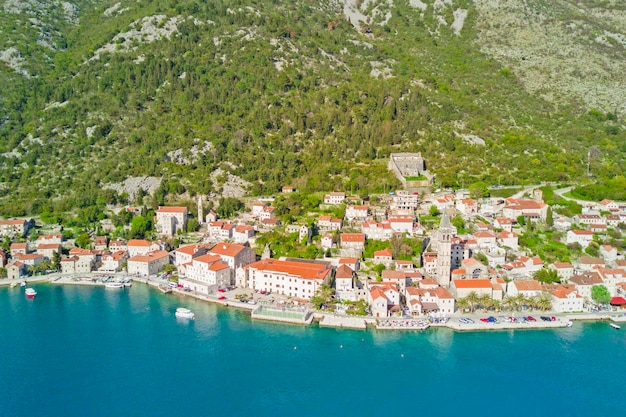 Beautiful city with red roofs in the mountains near the sea