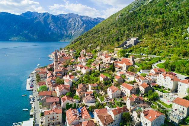 Beautiful city with red roofs in the mountains near the sea