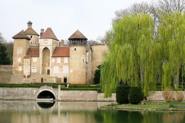 Beautiful classic castle in the south of France with moat and a beautiful weeping willow