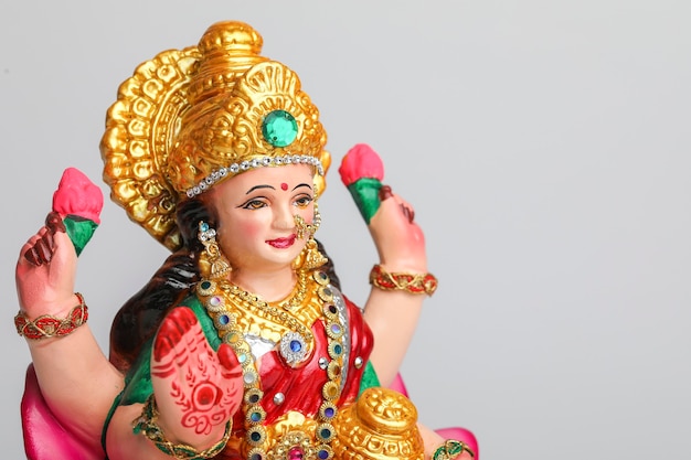 Beautiful Clay Idol of Hindu Goddess Lakshmi OR Laxmi on white 