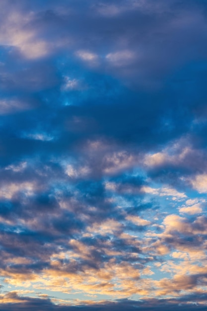 Beautiful clouds in blue sky illuminated by rays of sun at colorful sunset to change weather Abstract meteorology background