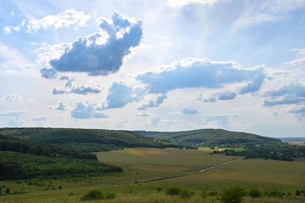 beautiful clouds over the road passing between the hills