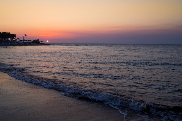 Beautiful cloudscape over the sea, sunset shot.majestic sunset over sea shore. romantic evening on the beach.freedom and inspiration over the ocean.waves on beach at sunset time , sunlight reflect