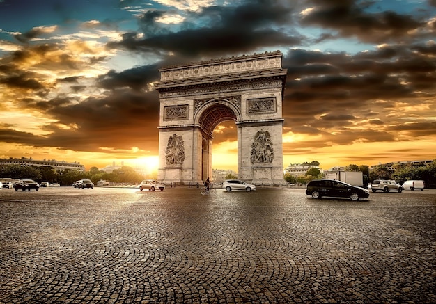 Beautiful cloudy sunset over Arc de Triomphe in Paris, France