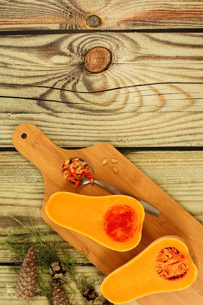 Beautiful colorful autumn pine cone and pumpkin on wooden background